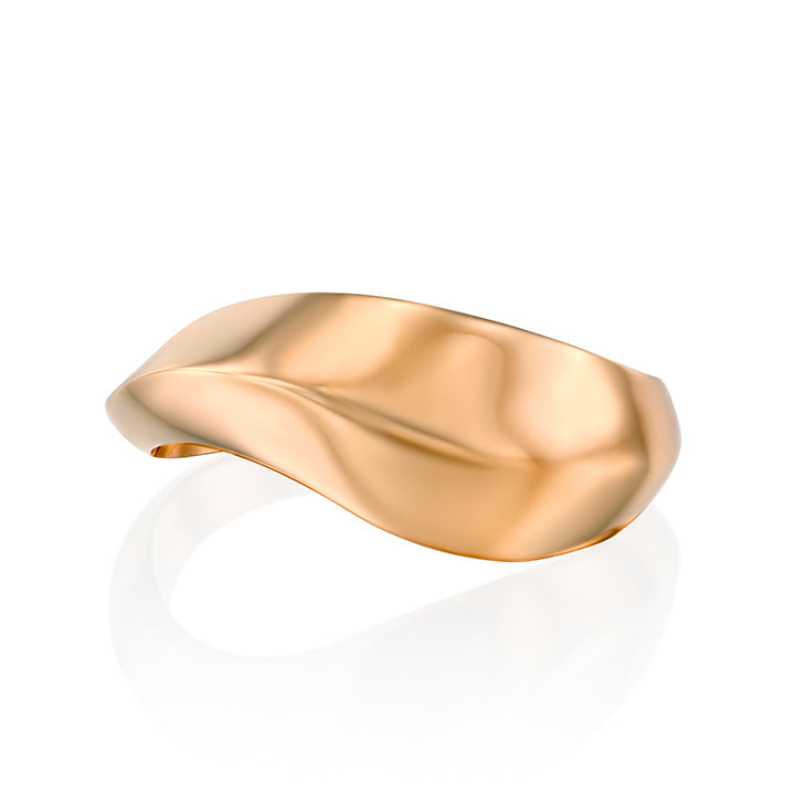 A wide geometric gold ring in a wave shape