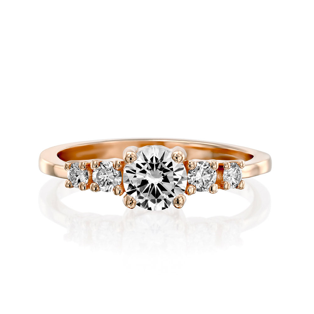 An engagement ring set with a central round lab diamond and 4 side lab diamonds