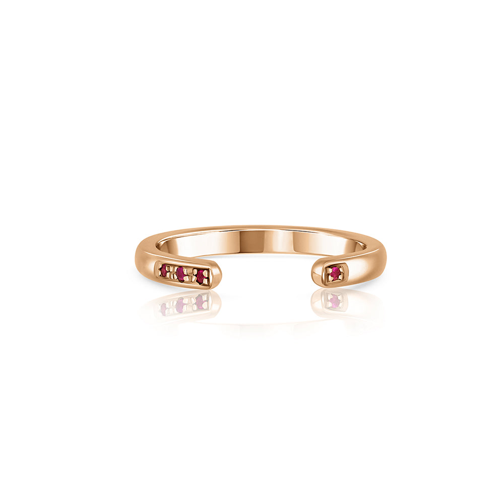 Open gold ring studded with rubies