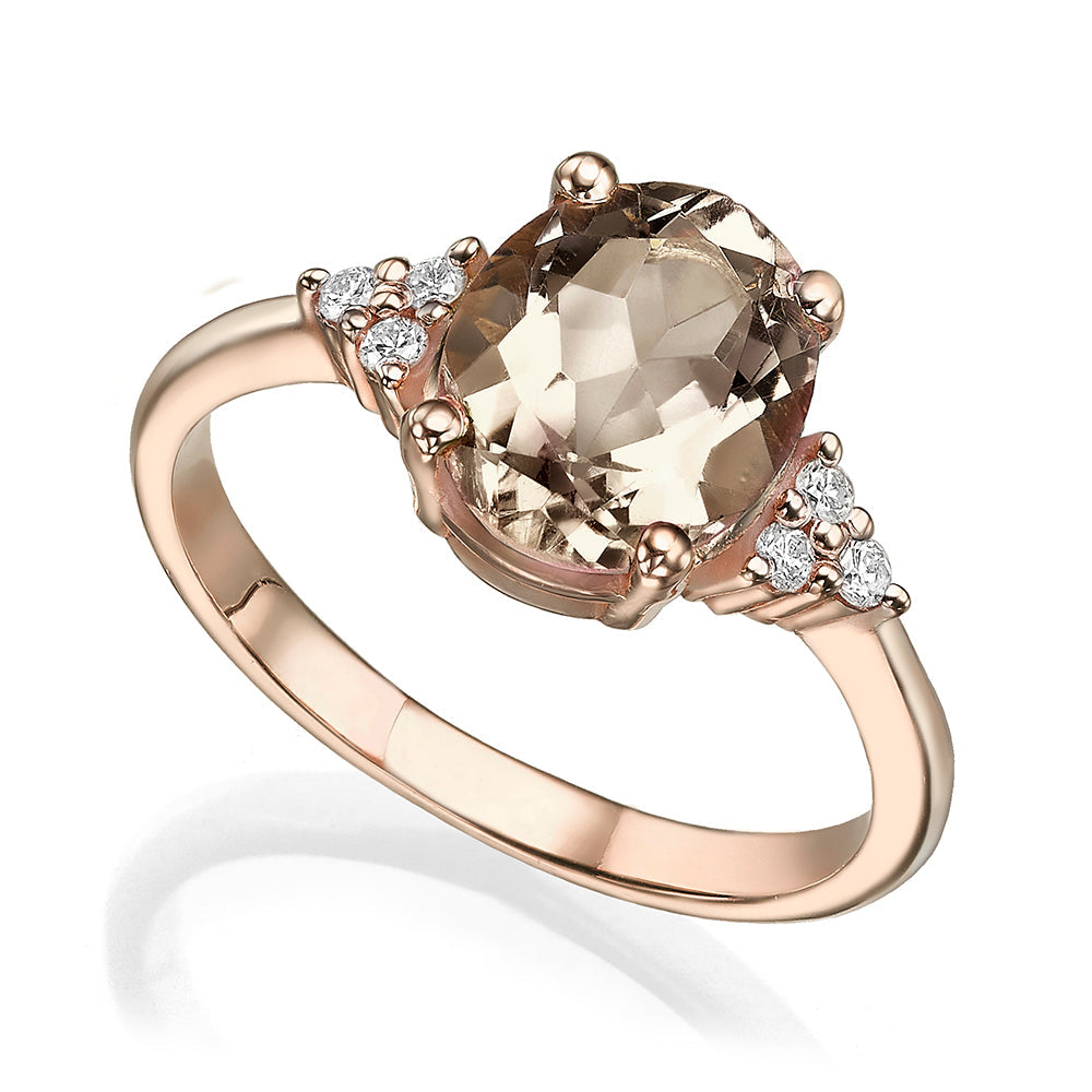 Gold ring set with light smoky quartz in an oval cut and diamonds
