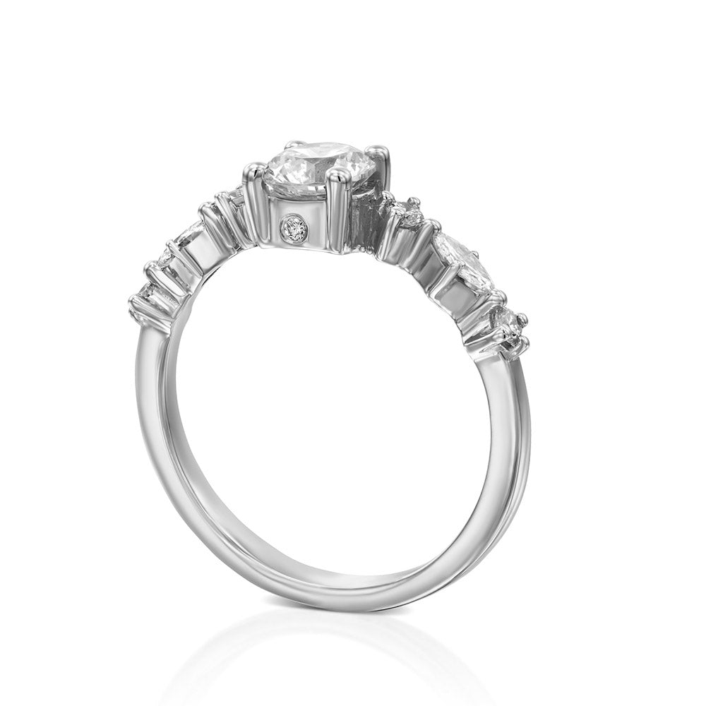 A diamond ring set with a 0.60 carat round diamond combined with marquise-cut diamonds