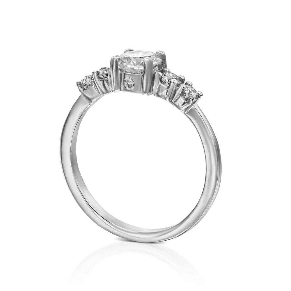 An engagement ring set with a central round lab diamond and 4 side lab diamonds