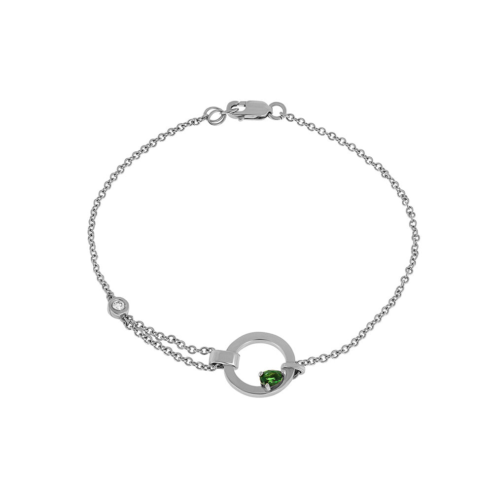 A special asymmetric gold bracelet, in a modern and impressive design. Inlaid green tourmaline and diamond.