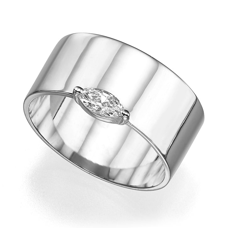 A wide gold ring set with a marquise-cut diamond
