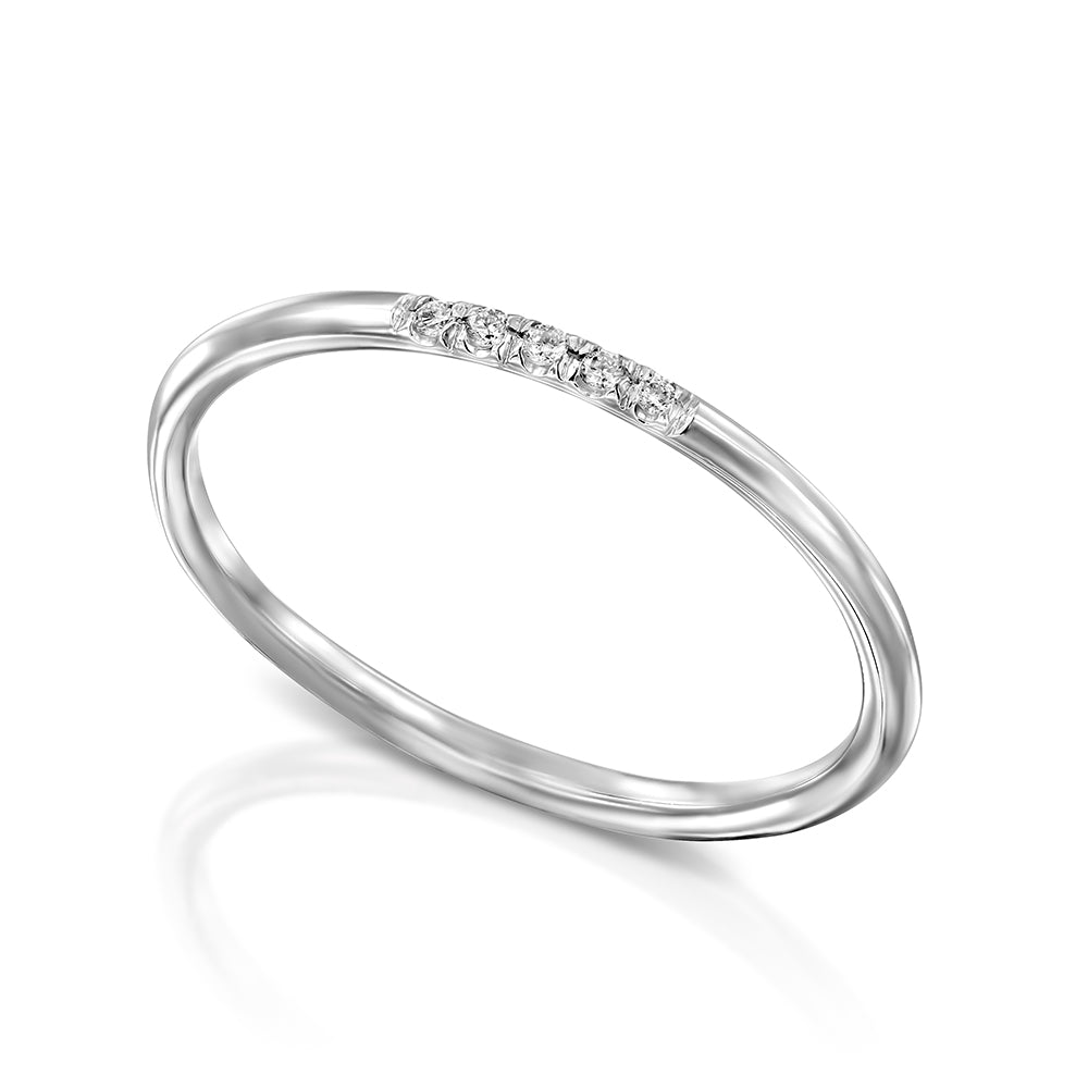 A thin gold ring with a round profile set with a row of five diamonds