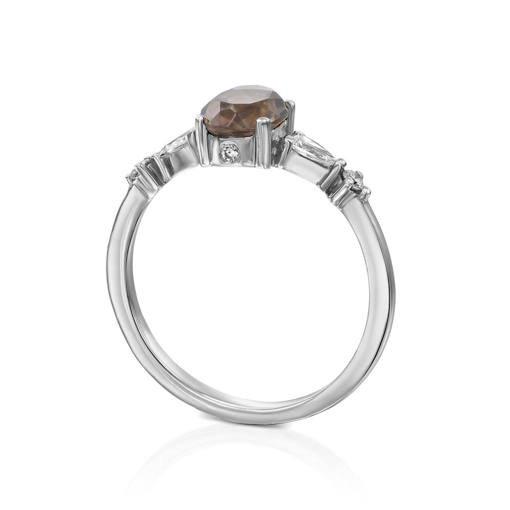 A gold ring set with smoky quartz and drop and round cut diamonds