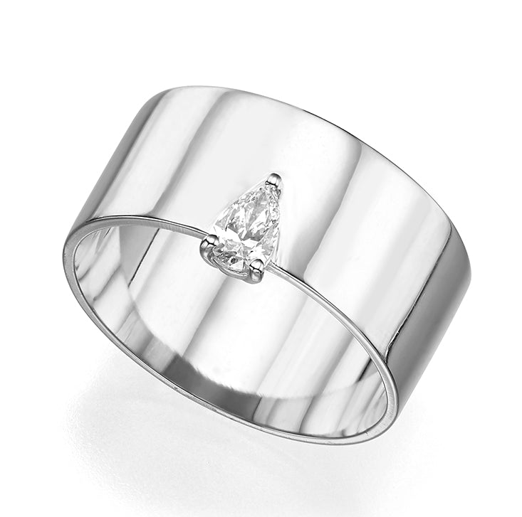 A wide gold ring set with a drop cut diamond