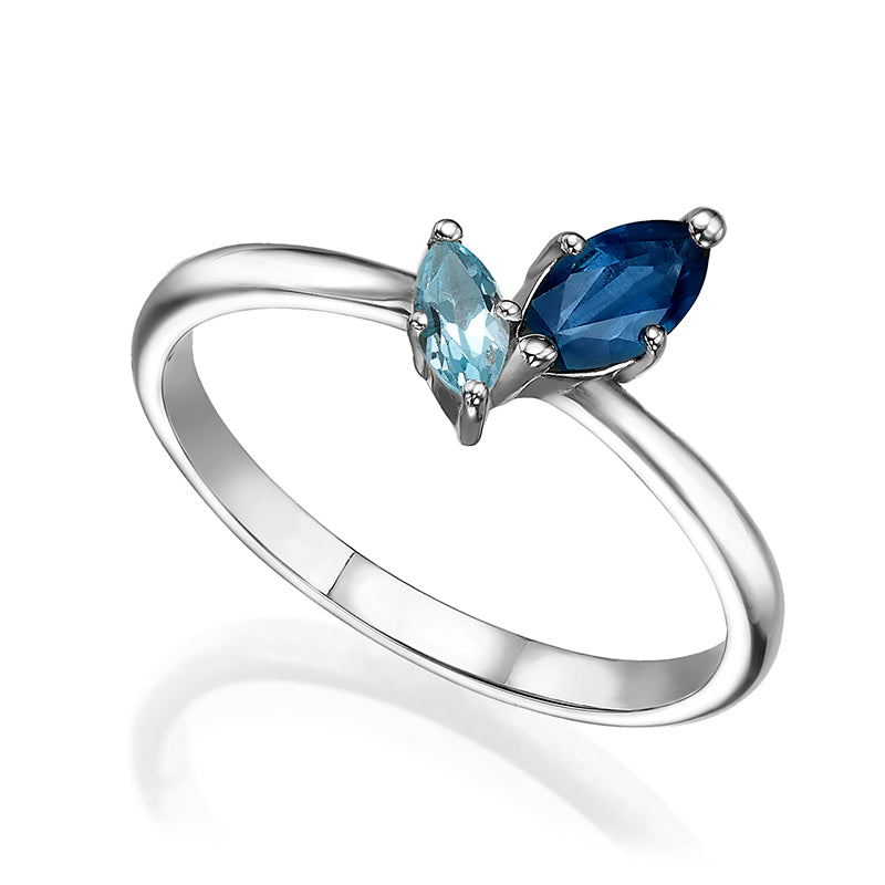 A special gold ring inlaid with sapphire and blue topaz in the shape of a marquise