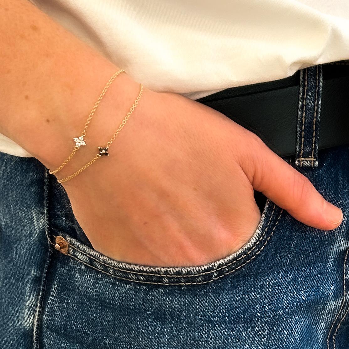Gold bracelet with 4 black diamonds in a flower design