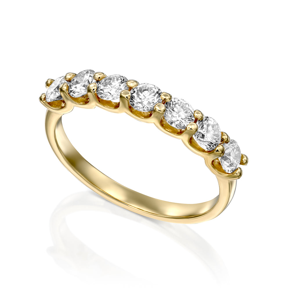 A gold ring set with 7 laboratory diamonds weighing 15 points per diamond