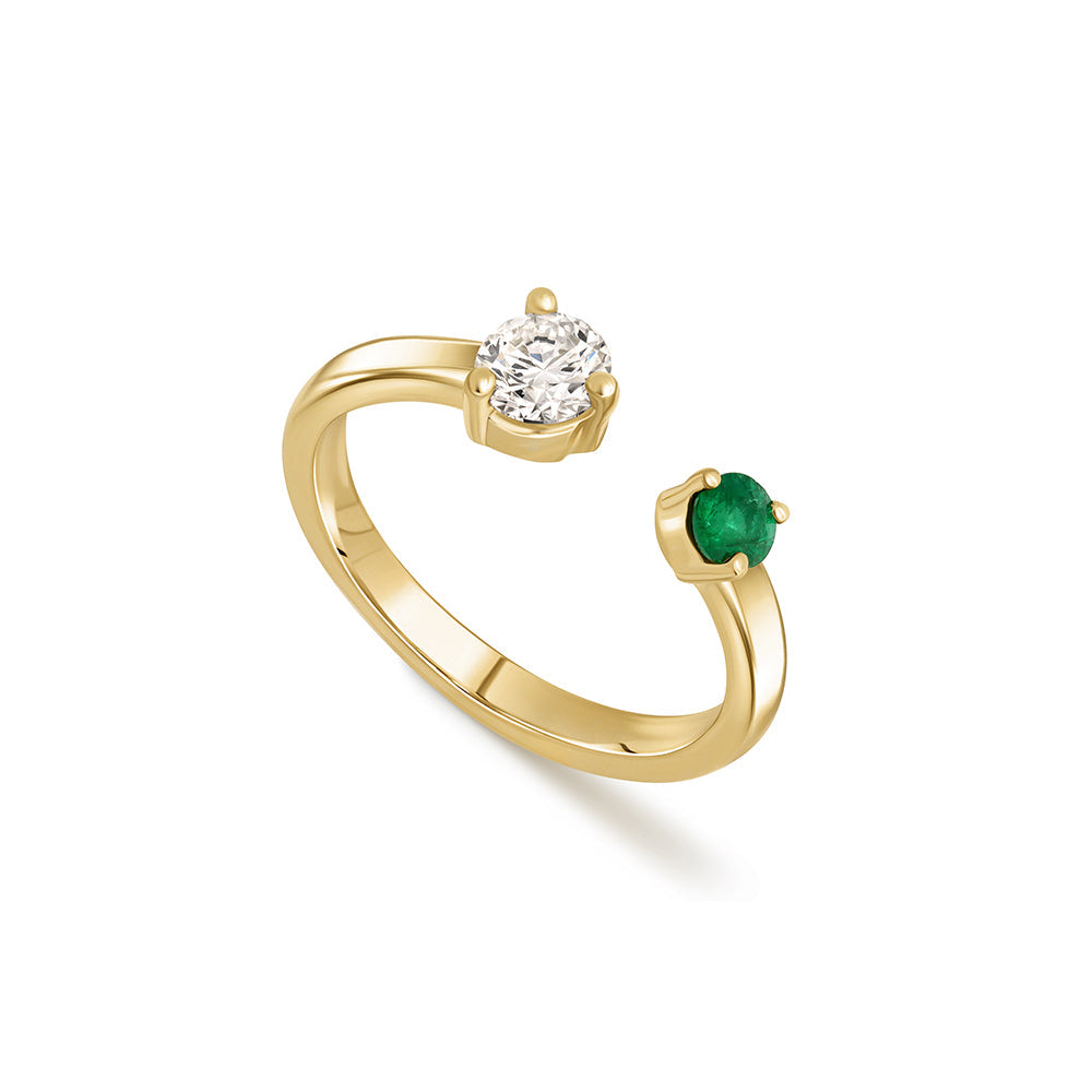Open gold and diamond ring. A ring set with a laboratory diamond weighing 30 points and a natural emerald.