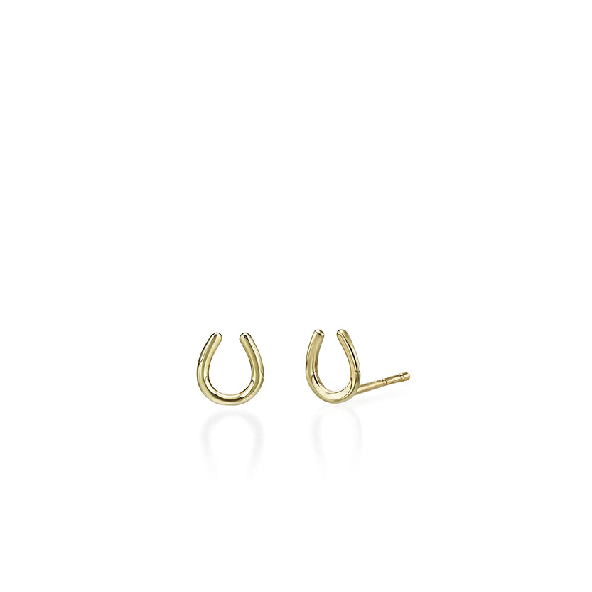 Small tight gold earrings in the shape of a horseshoe