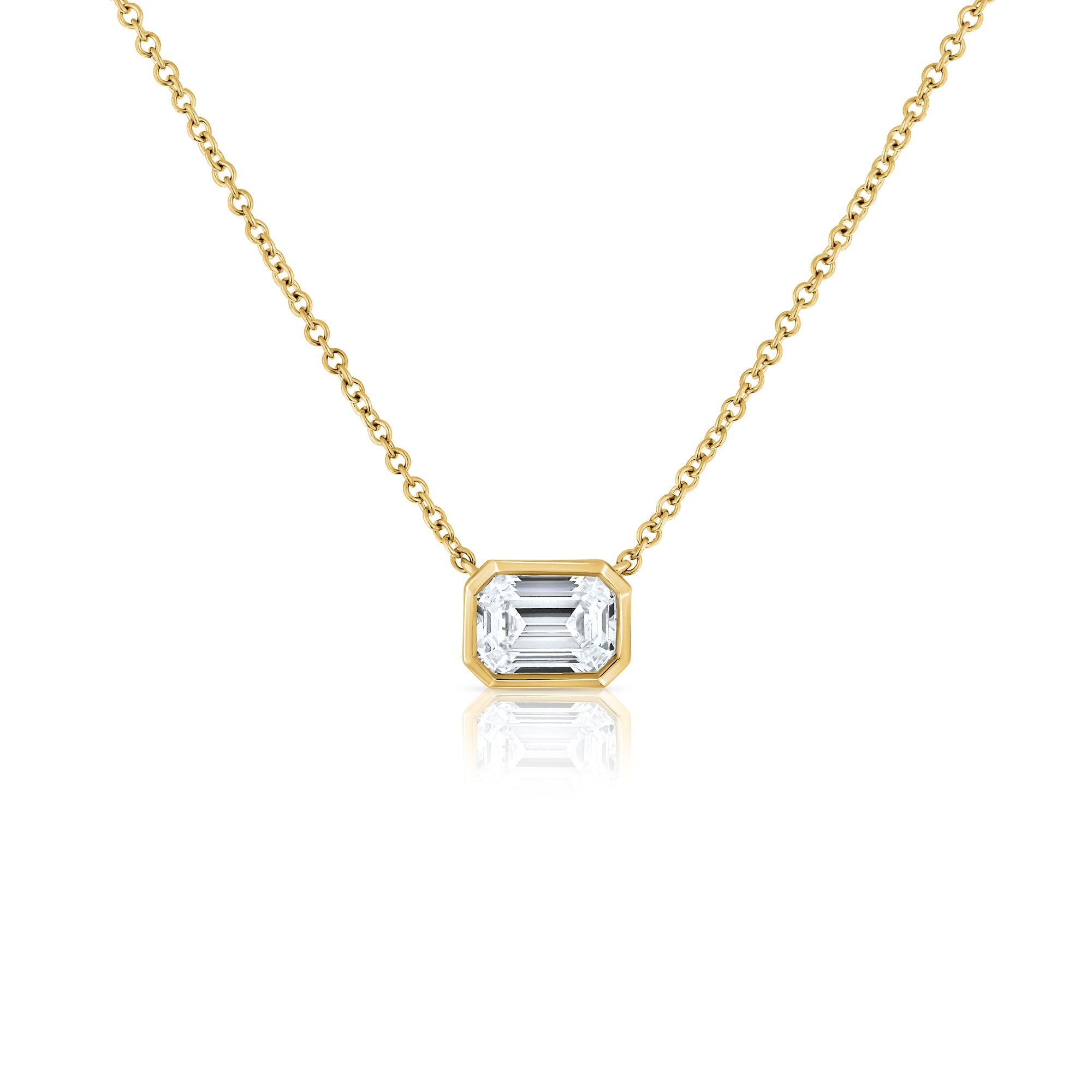 A classic gold necklace set with a 1 carat emerald cut lab diamond