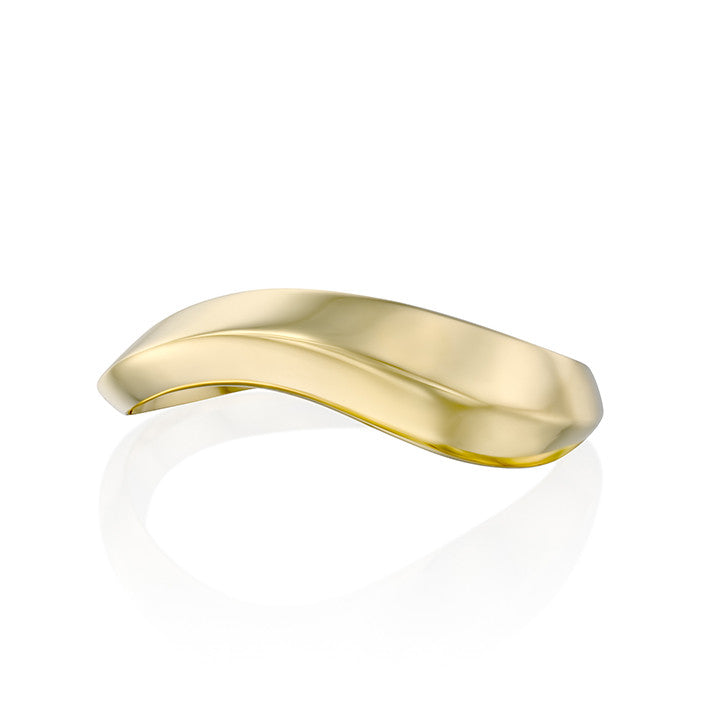 A thick geometric wave-shaped gold ring