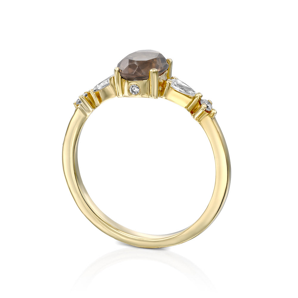 A gold ring set with smoky quartz and drop and round cut diamonds