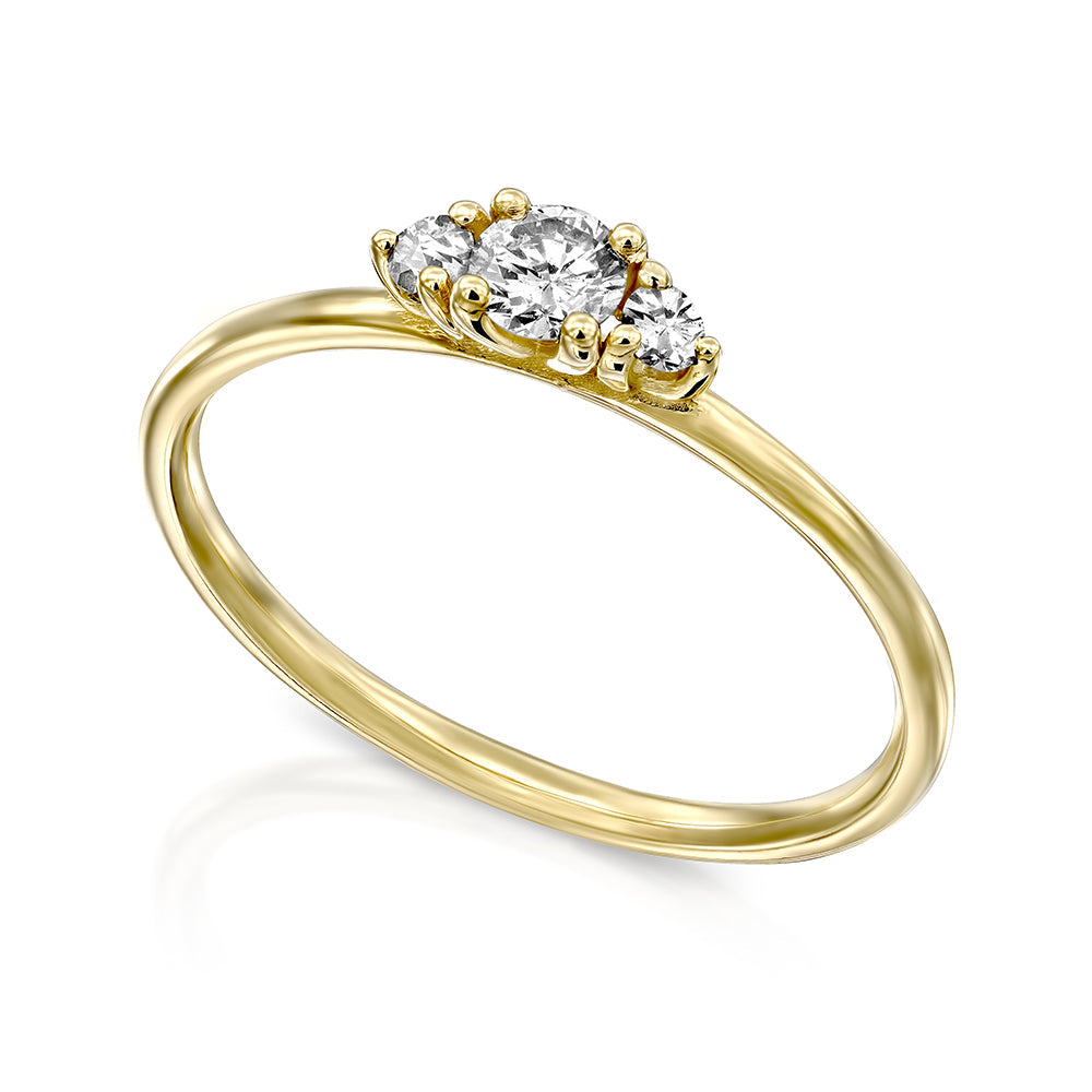 A delicate gold ring set with three white diamonds