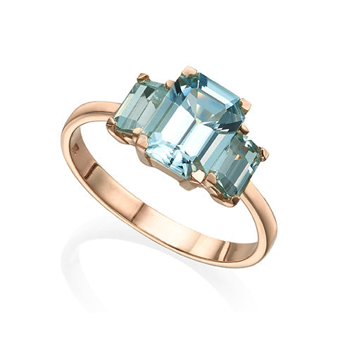 A gold ring inlaid with 3 aqua marine in a rectangular cut