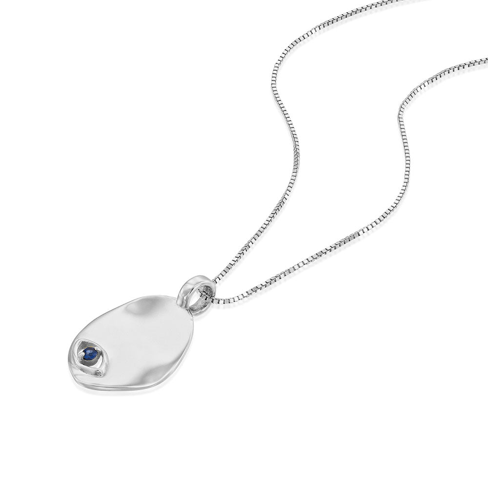Gold necklace with an amorphous pendant with a sapphire inlaid eye decoration
