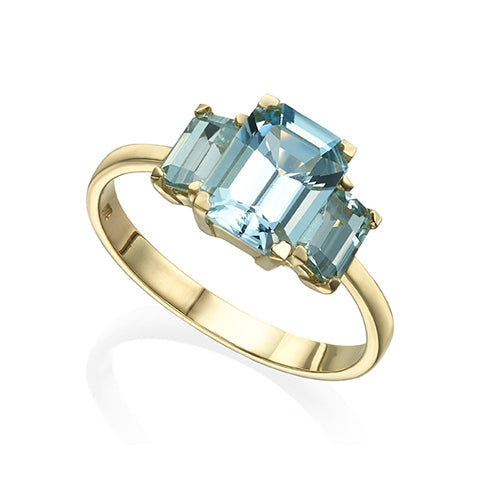 A gold ring inlaid with 3 aqua marine in a rectangular cut